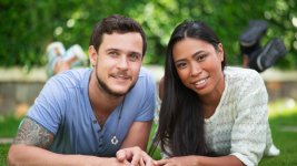 smiling-interracial-couple-relaxing-patio-grass2.jpg